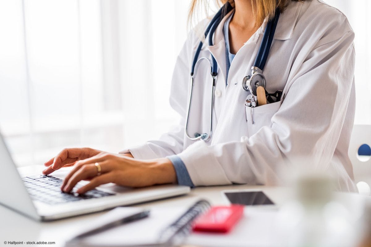 female doctor typing on a laptop